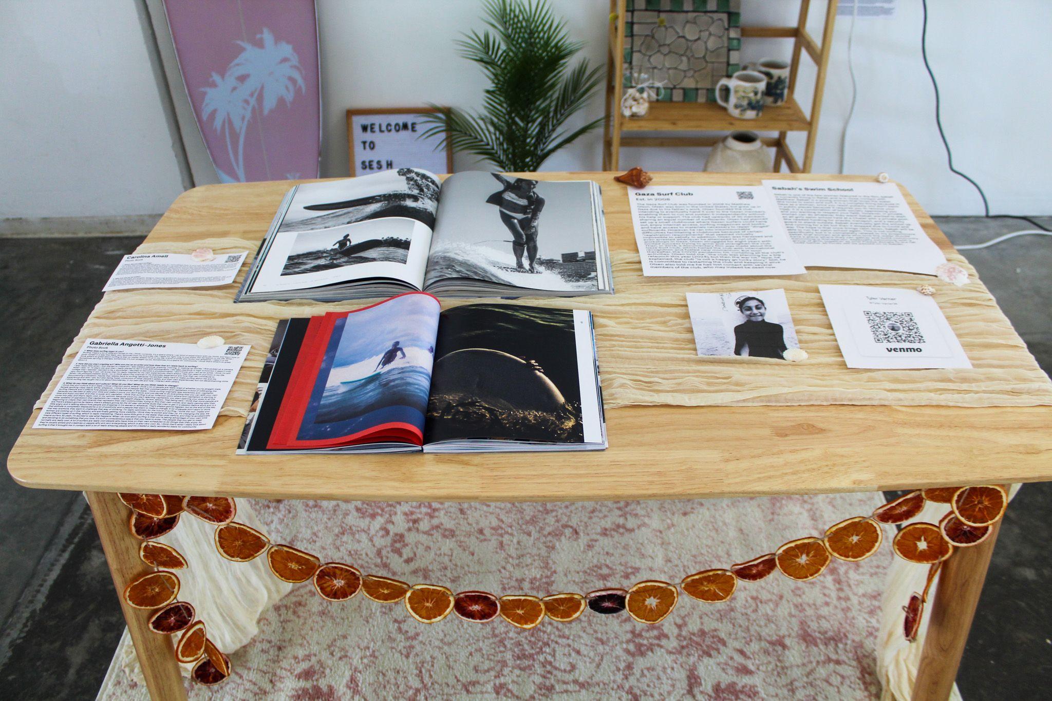 A close up image of the table shows two surfing magazines, next to two printed articles.