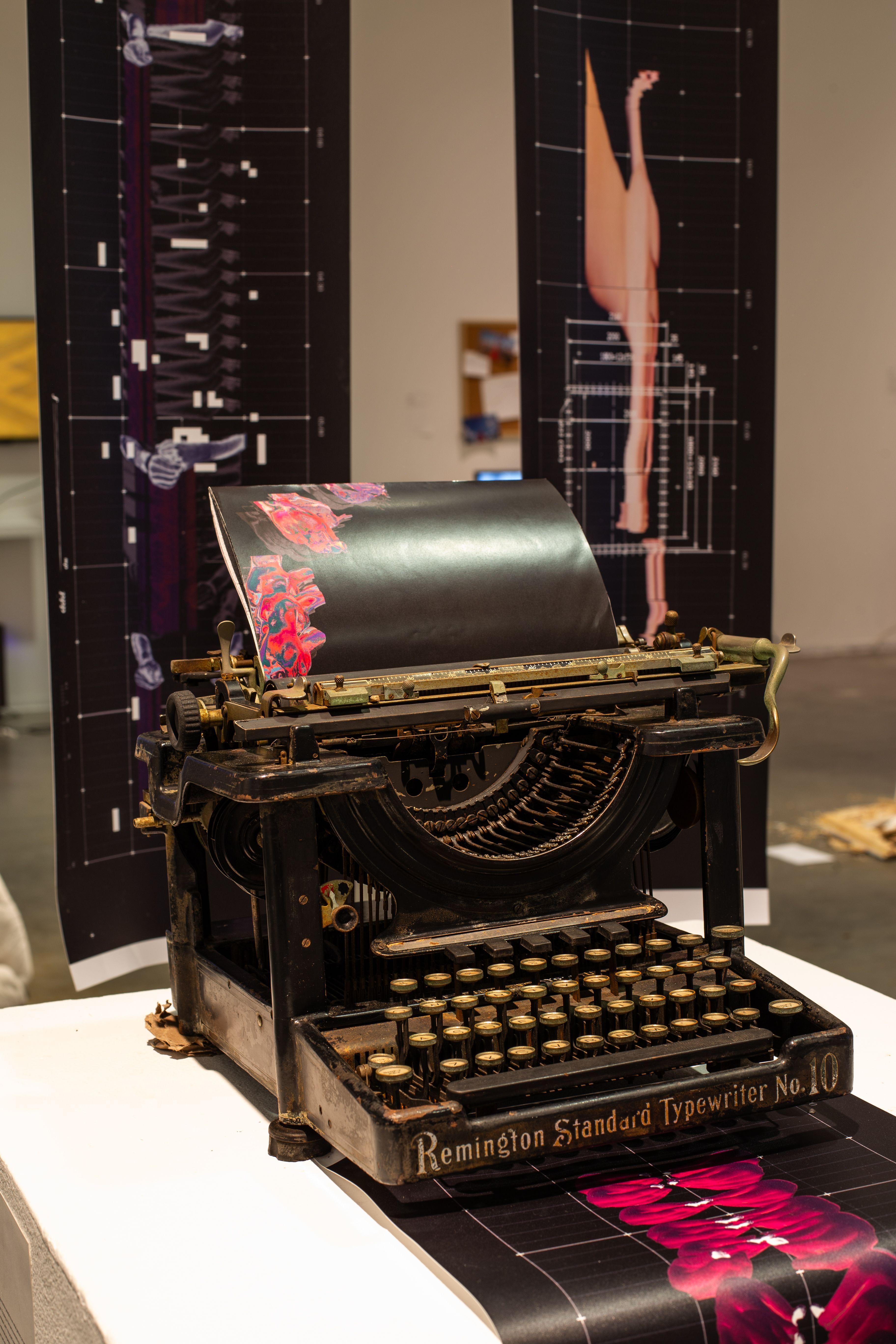 A Remington Standard Typewriter, from which a banner with abstract warped form semerges.