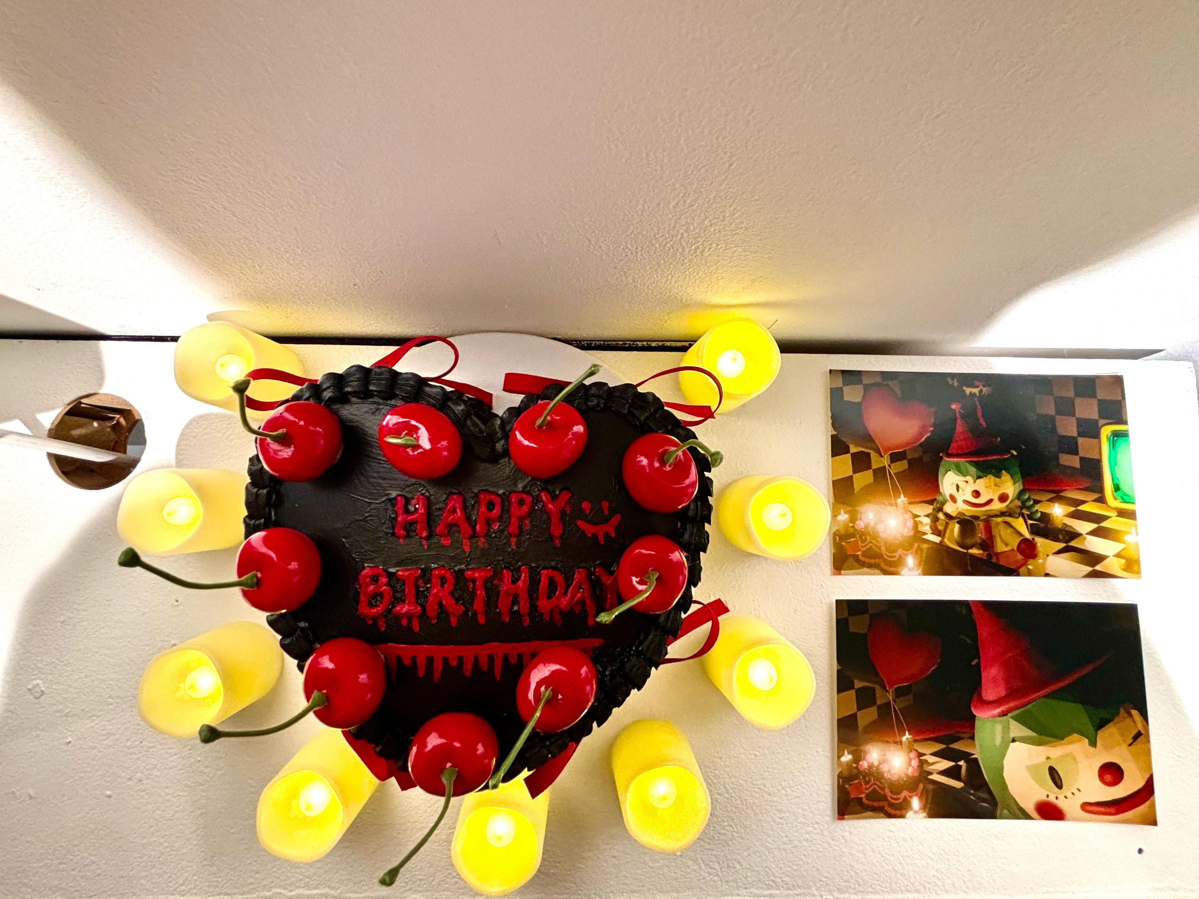 Close up image of a heart-shaped birthday cake surrounded by candles, next to two photographs of the clown animation.