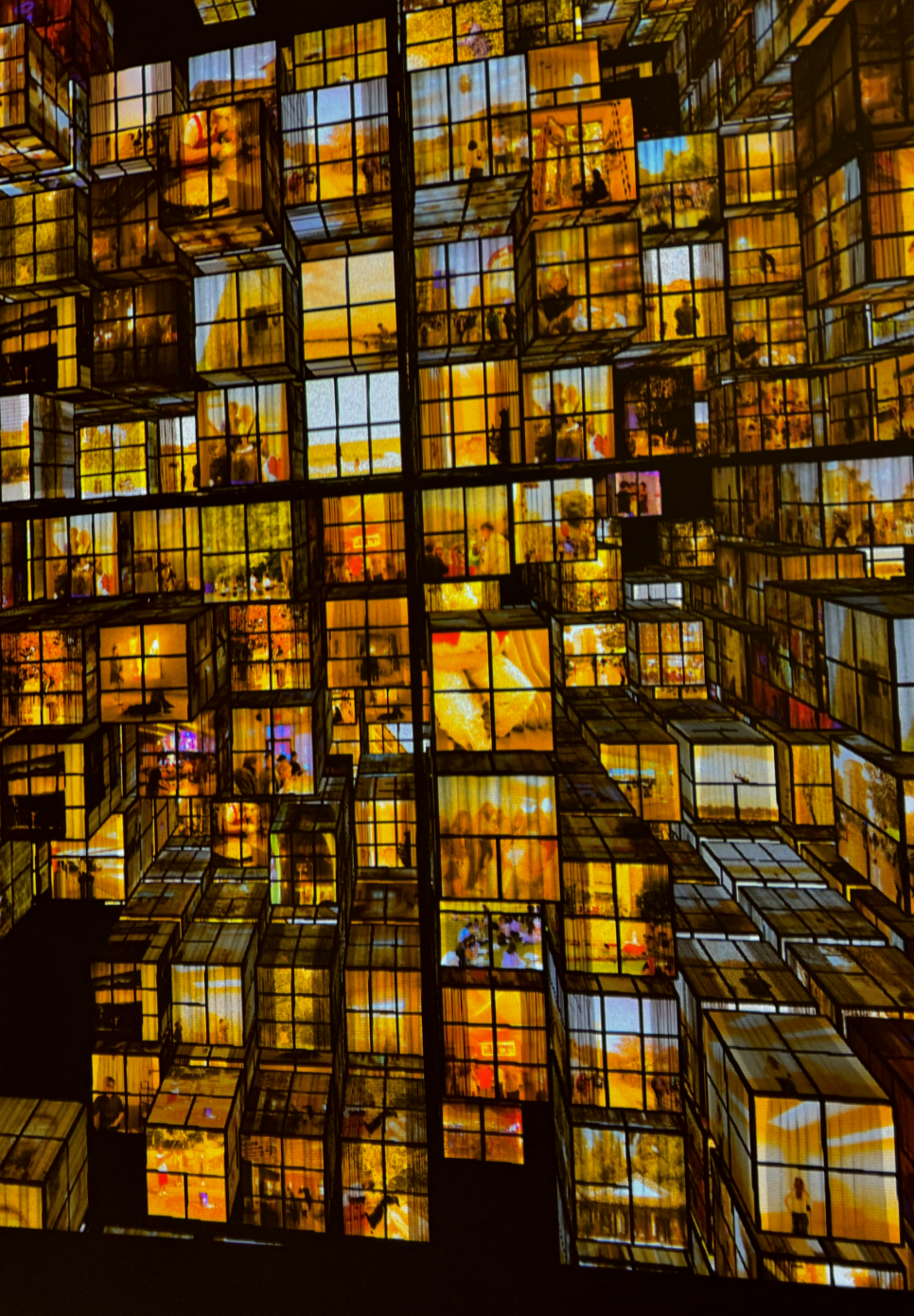 A close up of the cube-shaped grid and the scenes of daily life occurring within each window.