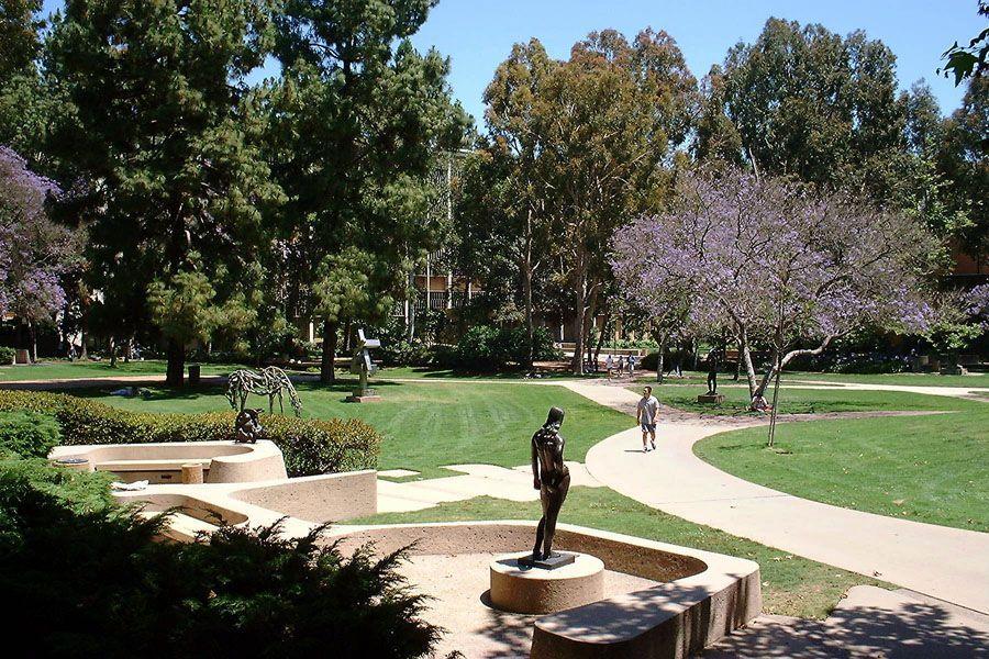 A winding path through a garden with sculptures.