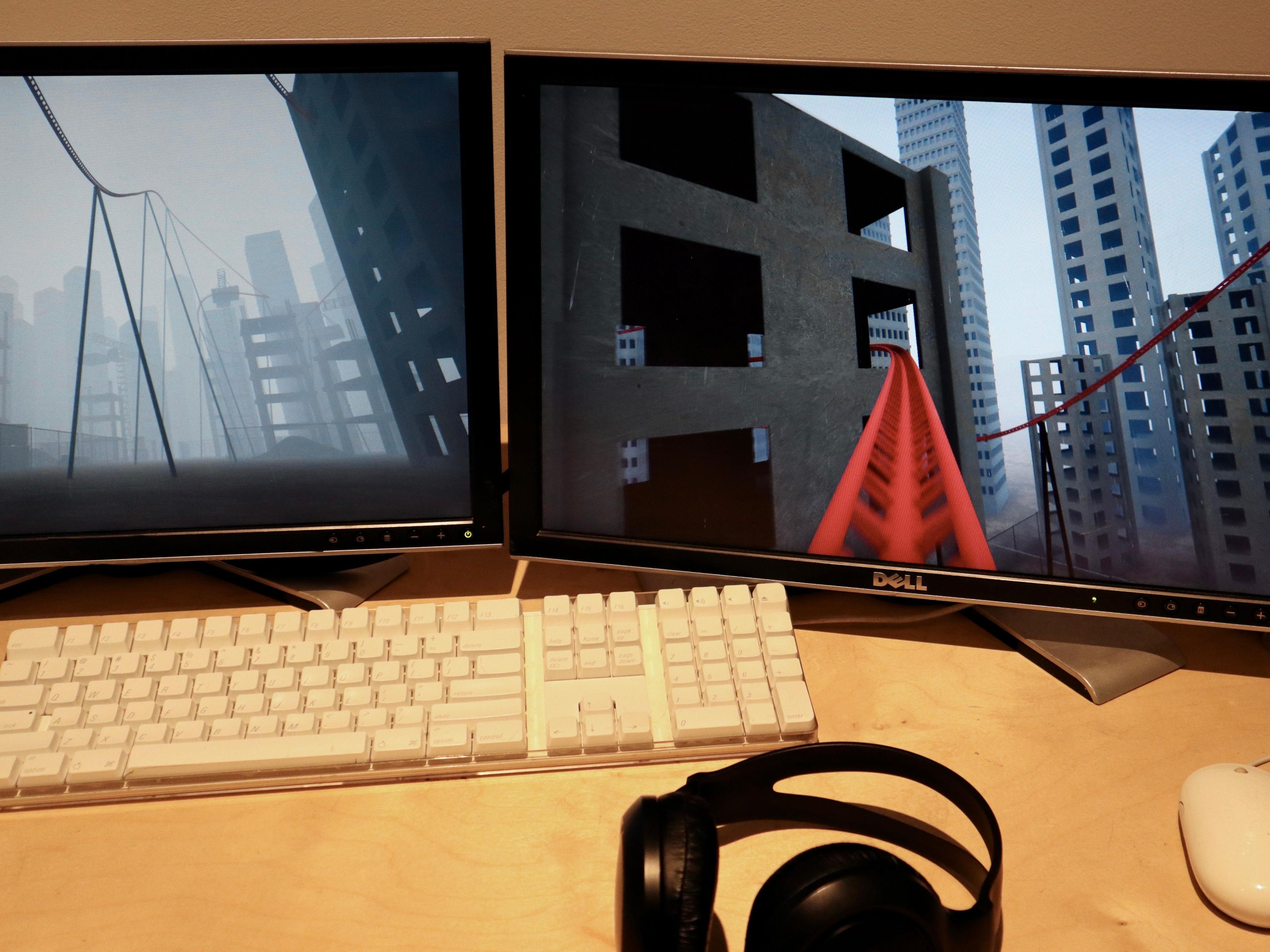 A desk with two monitors where the game is being played.