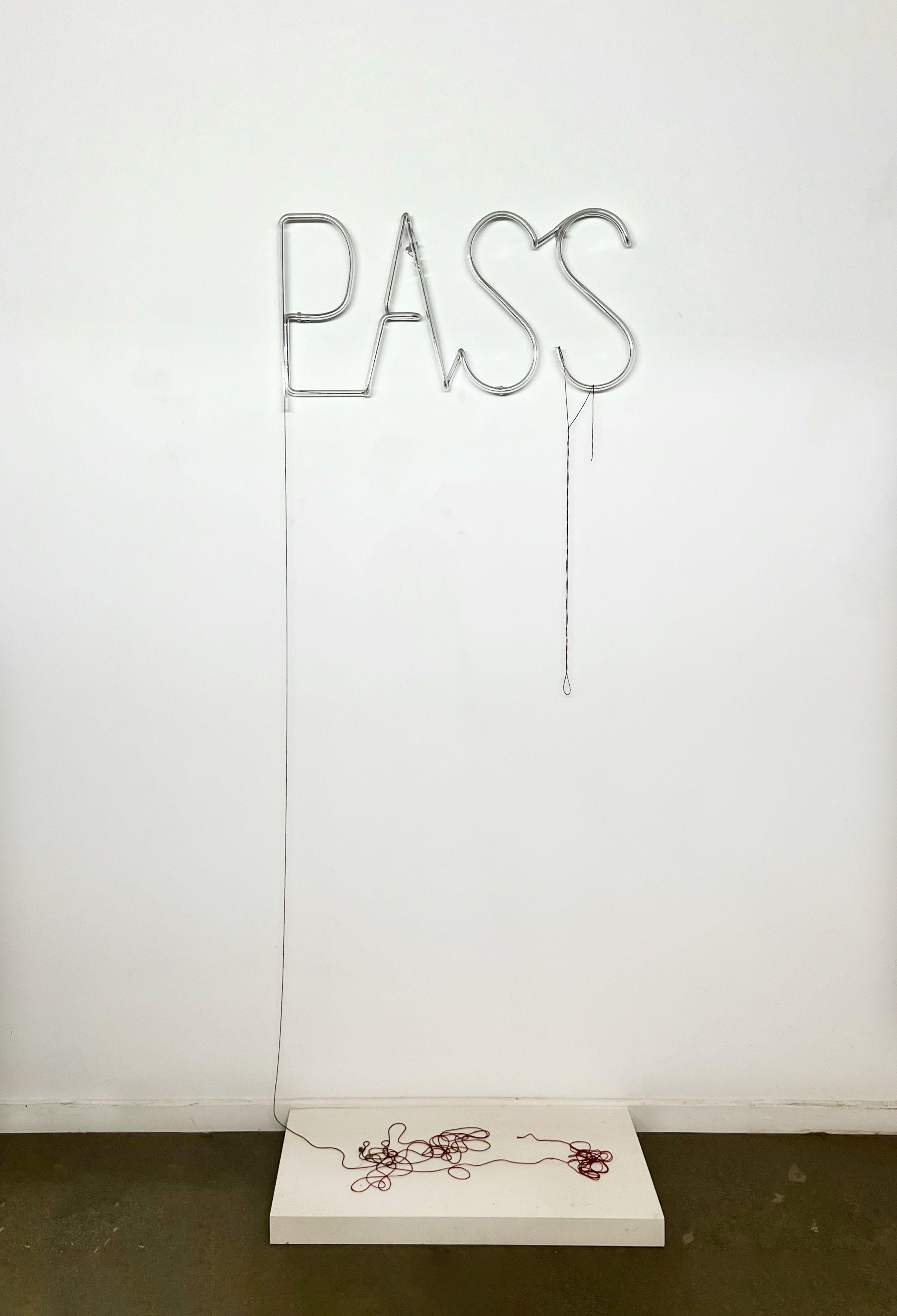 The text "pass" made out of clear glass tubing. The tubing has a red thread threaded through it. It falls to the floor and sits on a small plinth.